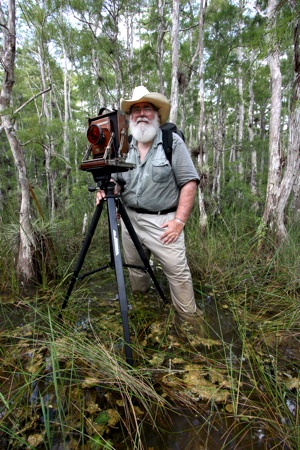 Renowned photographer Clyde Butcher working in the swamps of Florida. 